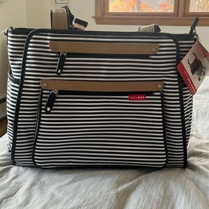 Brand new diaper bag, black and white stripes with faux leather detail.